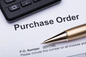 Close-up Of Pen And Purchase Order Form